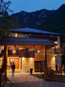 a man walking in front of a building at Rafting centar RT in Foča
