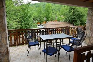 a patio with tables and chairs on a balcony at Rafting centar RT in Foča