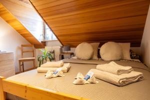 a large bed with towels on it in a room at Zum Alten Turm in Hennef +96 photos