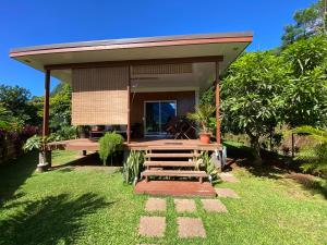 a small house with a porch and a deck at Fare Maraea in Moorea