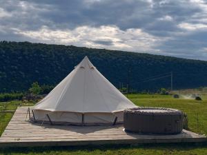 a white tent sitting on a wooden deck at ILLU Glamping in Trebujeni