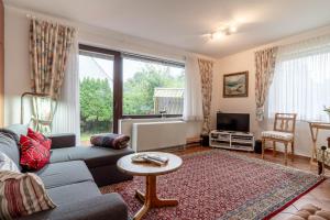 a living room with a couch and a table at Romantica EG in Sankt Peter-Ording