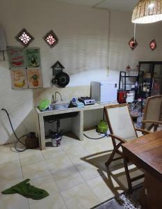 a kitchen with a sink and a desk in a room at Gs Homestay in Banyuwangi
