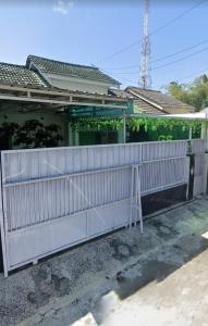 a white fence in front of a house at Gs Homestay in Banyuwangi