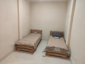 two beds in a small room withermottermottermott at Hotel RELAX TIME in Lanch'khut'i