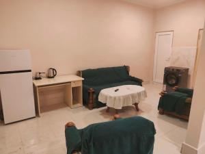 a living room with a couch and a table at Hotel RELAX TIME in Lanch'khut'i