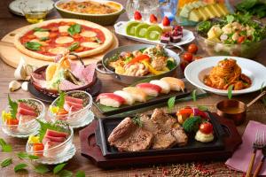 a table with many different types of food on it at Ooedo Onsen Monogatari Awara in Awara