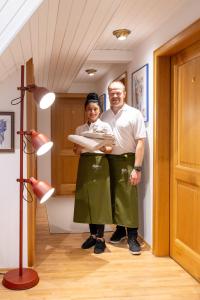 a man and a woman holding a baby in a room at Zum Alten Turm in Hennef