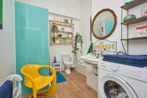 a bathroom with a washing machine and a mirror at Enjoy Sandown 1 in Sandown