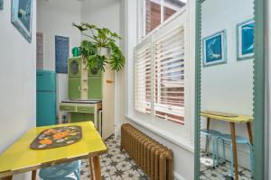 a dining room with a table and a window at Enjoy Sandown 1 in Sandown