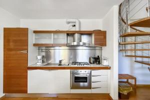 a kitchen with a sink and a stove at La Piazza Menaggio in Menaggio