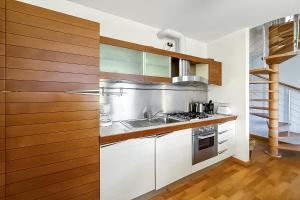 a kitchen with a sink and a stove at La Piazza Menaggio in Menaggio