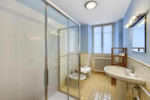 a bathroom with a shower and a toilet and a sink at La Piazza Menaggio in Menaggio +14 photos