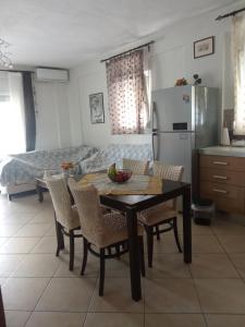 a kitchen with a table and chairs and a refrigerator at SOFI APARTMENT in Ofrínion