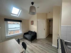 a living room with a black couch and a window at Charming 1Bed Flat In Dublin Sleeps 2 in Dublin