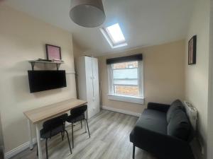 a living room with a couch and a table at Charming 1Bed Flat In Dublin Sleeps 2 in Dublin