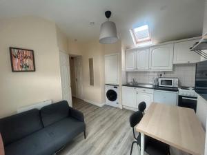 a living room with a couch and a kitchen at Charming 1Bed Flat In Dublin Sleeps 2 in Dublin