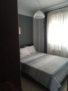 a bedroom with a bed and a window at SOFI APARTMENT in Ofrínion