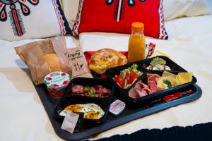 a tray of food sitting on a bed with food at Domek Pod Wierchami z Jacuzzi in Kościelisko