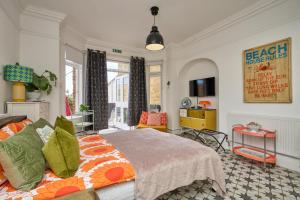 a bedroom with a bed and a living room at Enjoy Sandown 1 in Sandown