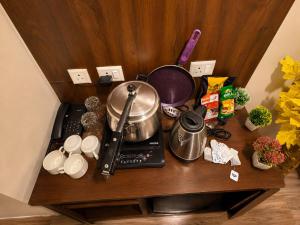 a table with a pot on top of a stove at Skycabinomaxe in Greater Noida