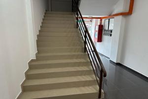 a staircase in a building with wooden railings at KM Barakah Suite Kuala Terengganu in Kuala Terengganu