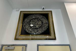 a picture with a gold frame on a wall at KM Barakah Suite Kuala Terengganu in Kuala Terengganu