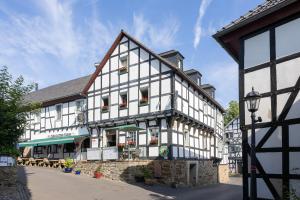 a large white building with flowers on the windows at Zum Alten Turm in Hennef