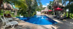 a swimming pool in the middle of a resort at Hallo Villa Khanom in Khanom