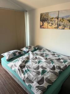 a bed with a comforter and pillows in a bedroom at Apartment Panger in Izola