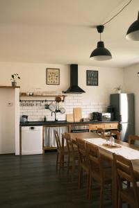 a kitchen with a table and chairs and a refrigerator at Chata Horalka in Jáchymov +36 photos
