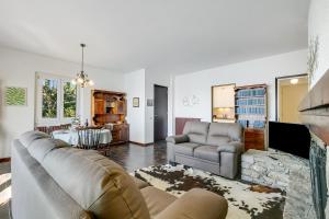a living room with a couch and a table at Lago Azzurro Villa: Infinity Lake View - Happy Rentals in Premeno