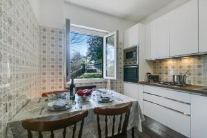 a kitchen with a table and chairs and a window at Lago Azzurro Villa: Infinity Lake View - Happy Rentals in Premeno