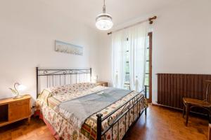a bedroom with a bed and a large window at Lago Azzurro Villa: Infinity Lake View - Happy Rentals in Premeno