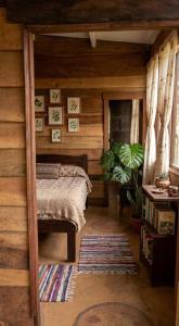 a bedroom with a bed in a wooden cabin at Paxel Forest in San Lorenzo El Cubo
