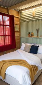 a bedroom with a large bed with a red window at Paxel Forest in San Lorenzo El Cubo