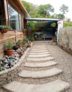 a garden with a stone walkway next to a house at Paxel Forest in San Lorenzo El Cubo
