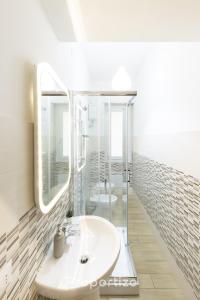a bathroom with a sink and a mirror at Central Cagliari by Propertize in Cagliari +42 photos