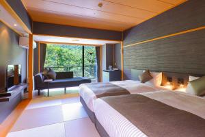 a bedroom with a large bed and a large window at TAOYA Nasu Shiobara in Nasushiobara
