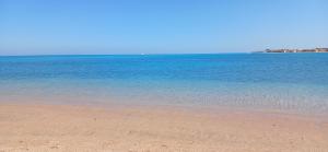 a view of the ocean with a sandy beach at Red Sea Serenity in Sharm El Sheikh