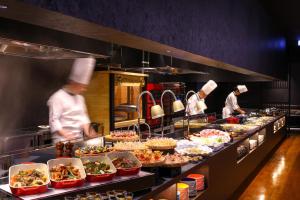 a group of chefs preparing food in a restaurant kitchen at TAOYA Nasu Shiobara in Nasushiobara