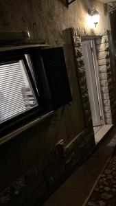 a room with a window and a light on a wall at Parenzana Apartment in Portorož