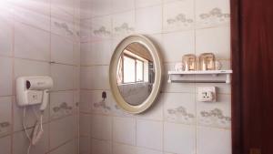 a bathroom with a mirror and a window at Ilemi Gardens in Nairobi