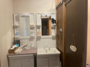 a bathroom with a sink and a mirror at まちやど　Motomachi in Daigo +43 photos