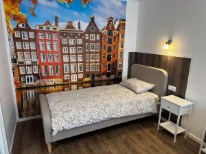 a bedroom with a bed and a window with buildings at Amstel LUX in Narva +6 photos