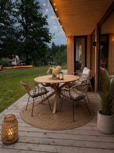 a wooden deck with a table and chairs at Radawa LOVE in Radawa +74 photos
