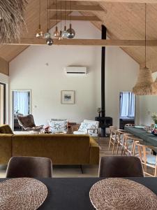 a living room with a couch and chairs at Radawa LOVE in Radawa