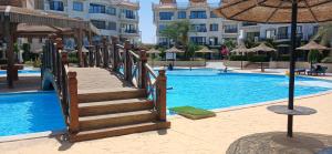 a staircase leading to a pool at a resort at Red Sea Serenity in Sharm El Sheikh