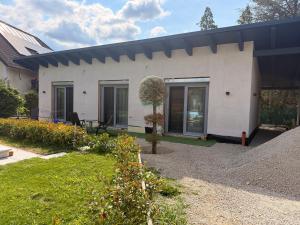 a white house with a black roof at Privatroom for rent in Bad Fischau