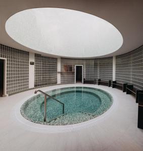 a large pool of water in a room with a ceiling at Červený Mlýn in Tišnov